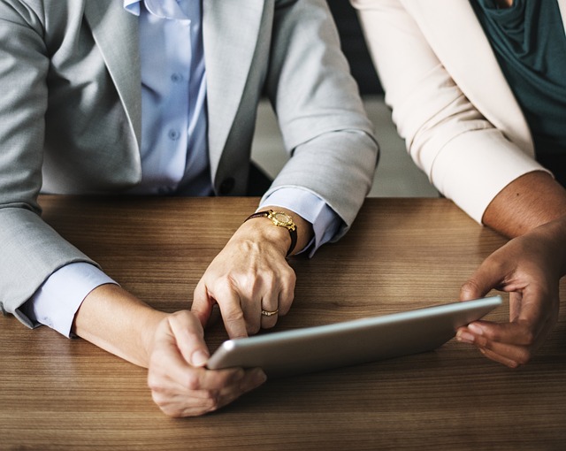 Two people reviewing data on an iPad